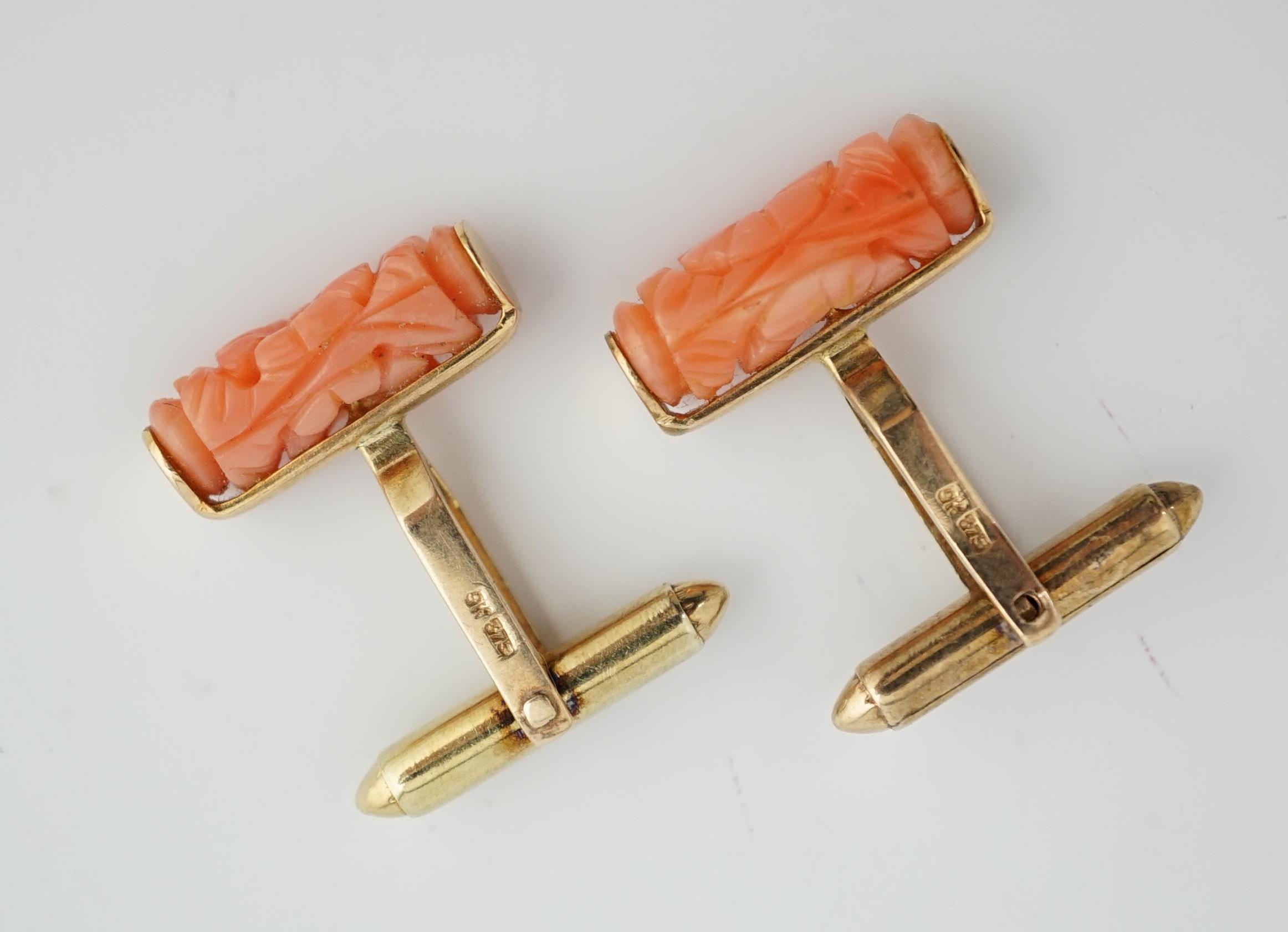 A pair of 9k gold and carved coral set cufflinks